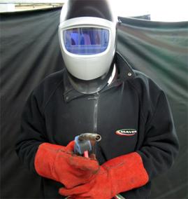 Welder in welding mask and protective clothing